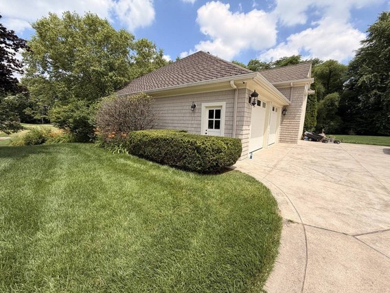 Striped lawn along curving driveway